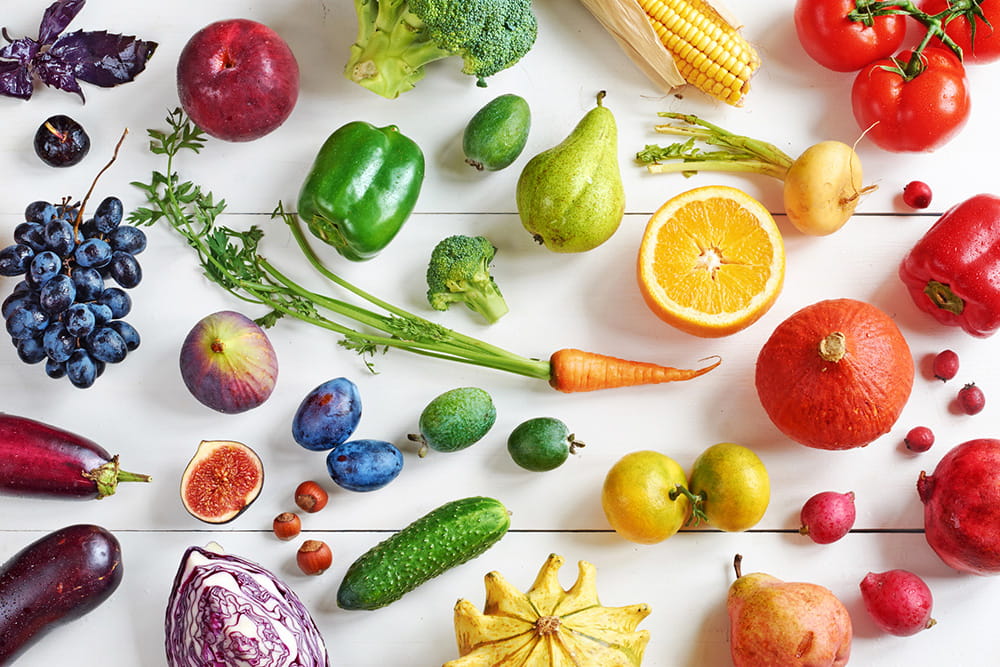 mix of fruits and veggies on colorful background